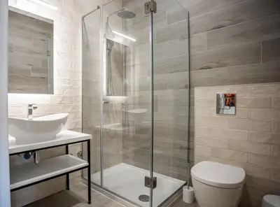 a bathroom with a shower and a toilet and a sink at Studio Pop Art in Batajnica