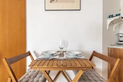 a wooden table with plates and wine glasses on it at Marshall Residence in Belgrade