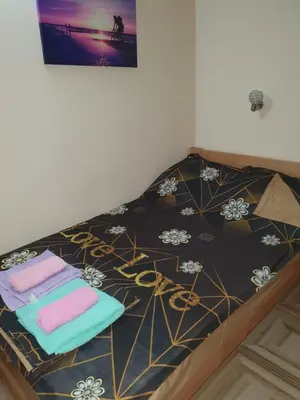 a bed with towels on top of it at Small cute doublebed room A4 in Pančevo in Pančevo