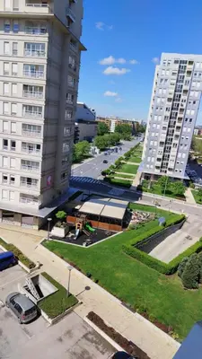 an aerial view of a large building and a parking lot at Manhattan studio Seboj Belvil in Novi Beograd