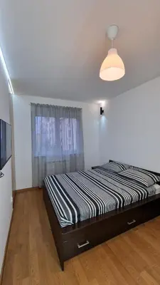 a bedroom with a bed and a window at Porodicno-poslovni udoban stan in Vračar (historical)