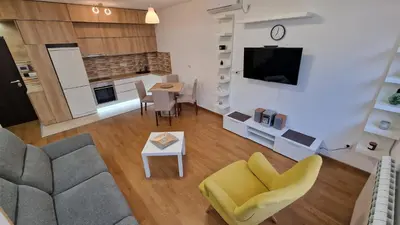 a living room with a couch and a table at Porodicno-poslovni udoban stan in Vračar (historical)