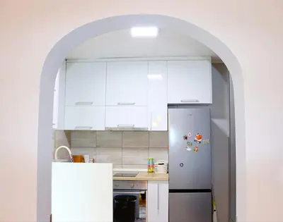 a kitchen with white cabinets and a refrigerator at Red Kruz in Vračar (historical)