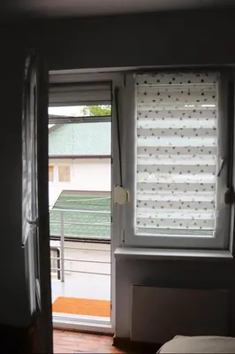 a window with a window shade with a view of a yard at Red Kruz in Vračar (historical)