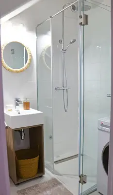 a bathroom with a glass shower and a sink at Red Kruz in Vračar (historical)