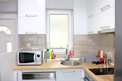 a kitchen with a microwave and a sink at Red Kruz in Vračar (historical)