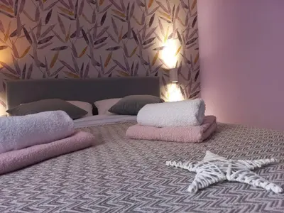 a bedroom with a bed with pillows and a skeleton on the floor at Apartman Central Place in Belgrade