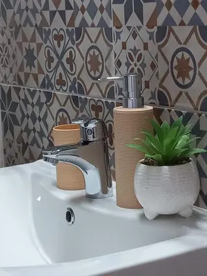 a bathroom sink with a faucet and a plant on it at Apartman Central Place in Belgrade