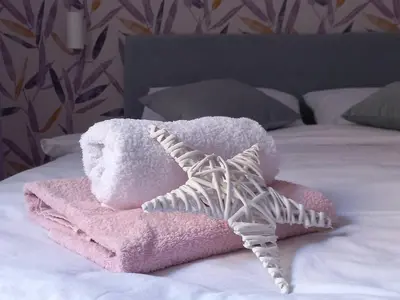 a stuffed animal on a bed with a towel at Apartman Central Place in Belgrade