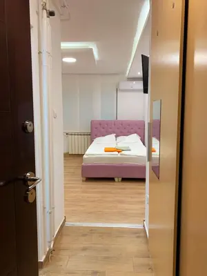 a bedroom with a bed with a purple bedvisor at LUX BANOVO BRDO apartman in Belgrade