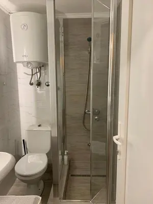a bathroom with a shower with a toilet and a sink at LUX BANOVO BRDO apartman in Belgrade