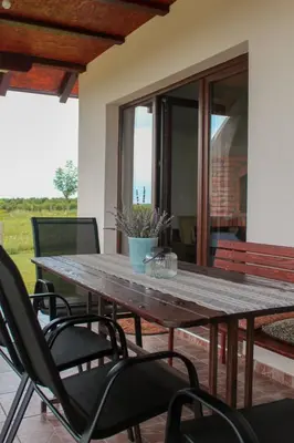 a wooden table and chairs on a patio at Villa Sladjana in Mladenovac