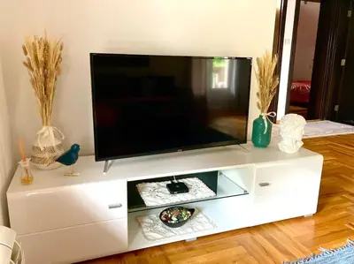 a white entertainment center with a flat screen tv on it at AmazingMemories3 in Belgrade