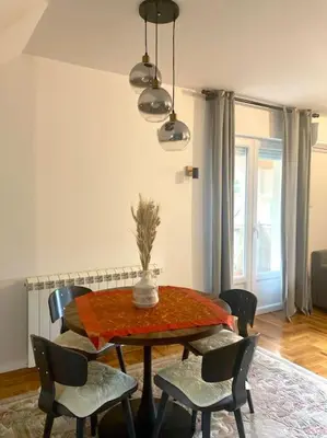 a dining room table and chairs in a room at AmazingMemories3 in Belgrade