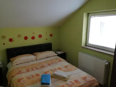 a bedroom with a bed and a window at Apartments Bella Mare Belgrade in Belgrade