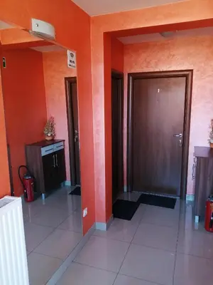 an empty hallway with orange walls and a door at Apartments Bella Mare Belgrade in Belgrade