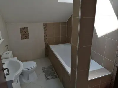 a bathroom with a tub and a toilet and a sink at Apartments Bella Mare Belgrade in Belgrade