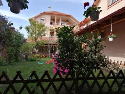 a house with a fence in front of a yard at Apartments Bella Mare Belgrade in Belgrade
