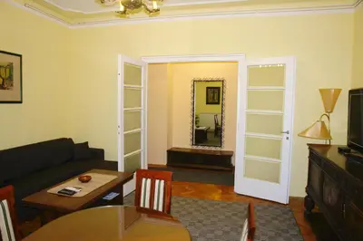 a living room with a couch and a table and a mirror at Apartment Tašmajdan in Belgrade
