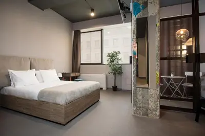 a hotel room with a bed and a window at Avangarda Suites in Belgrade