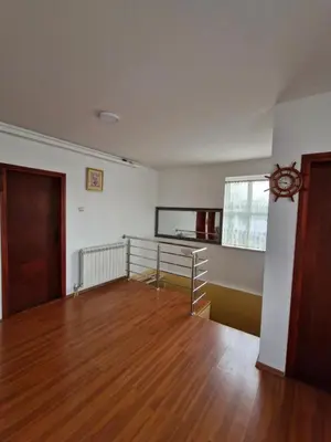 an empty room with a wooden floor and a window at Vila Soleil in Smederevo