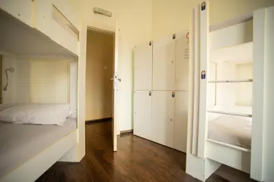 a small bedroom with a bed and a bunk room at All in Hostel in Belgrade