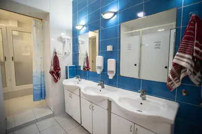 a bathroom with two sinks and a mirror at All in Hostel in Belgrade