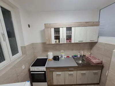 a small kitchen with a sink and a stove at Apartment BeoSun in Belgrade