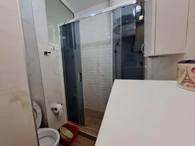 a small bathroom with a shower and a toilet at Apartment BeoSun in Belgrade