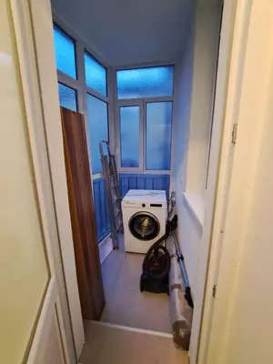 a bathroom with a washing machine in a room with a window at Apartment BeoSun in Belgrade