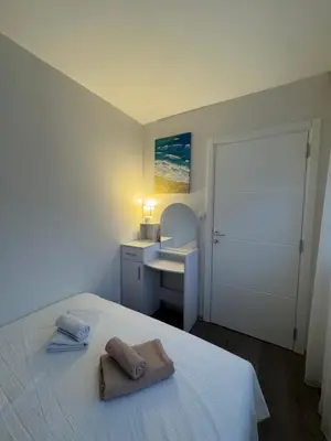 a bedroom with a bed with a sink and a mirror at Apartman Marija in Zvezdara