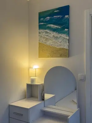 a room with a bed and a painting on the wall at Apartman Marija in Zvezdara
