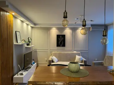 a living room with a table and a couch at Apartman Marija in Zvezdara