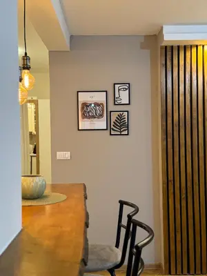 a dining room with a table and a chair at Apartman Marija in Zvezdara