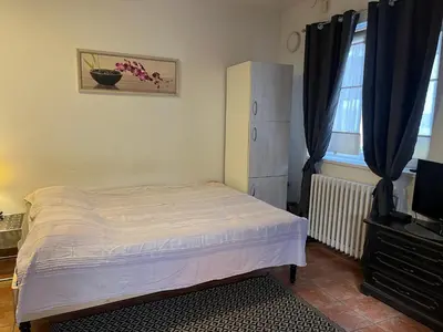 a small bedroom with a bed and a television at Studio Vracar in Belgrade