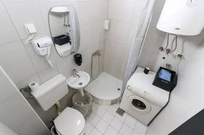 a small bathroom with a toilet and a sink at Studio Vracar in Belgrade
