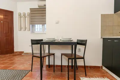 a black table and two chairs in a kitchen at Studio Vracar in Belgrade
