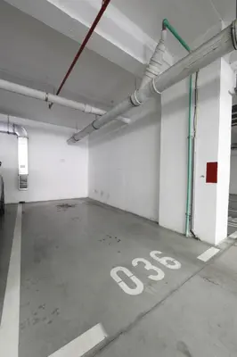 a parking garage with a stop sign on the floor at A blok - One bedroom apartment in Belgrade
