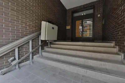a building with stairs and a door and a brick wall at A blok - One bedroom apartment in Belgrade