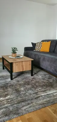 a living room with a couch and a coffee table at JR Lux apartman in Stara Pazova