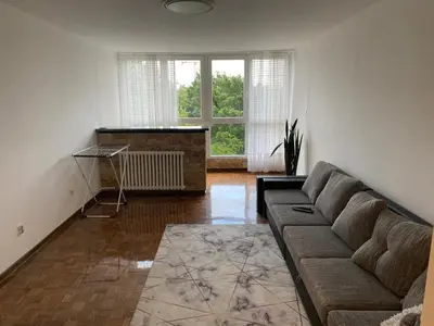 a living room with a couch and a large window at Novi Beograd Dr.Agostina Neta in Novi Beograd