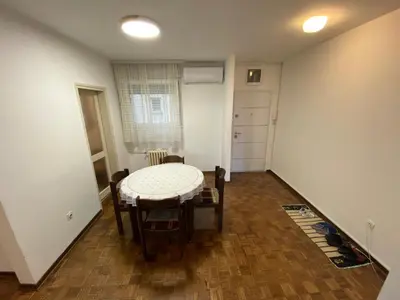 a small room with a table and chairs in it at Novi Beograd Dr.Agostina Neta in Novi Beograd