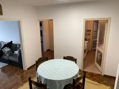 a living room with a table and a couch at Novi Beograd Dr.Agostina Neta in Novi Beograd