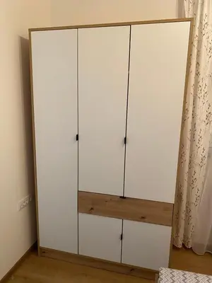 a white cabinet with four doors in a room at Apartman Popović in Ruma