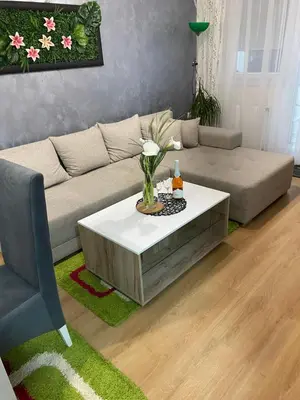 a living room with a couch and a table at Apartman Popović in Ruma