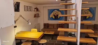a living room with a table and a spiral staircase at Micro in Belgrade