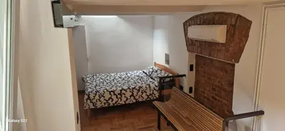 a small room with a bed and a bench at Micro in Belgrade