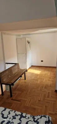 an empty room with a wooden floor and a bench at Micro in Belgrade