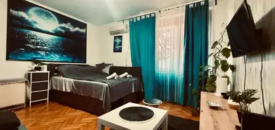 a bedroom with a bed with blue drapes at Apartman Moon in Belgrade