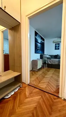 a living room with a view of a bedroom with a mirror at Apartman Moon in Belgrade